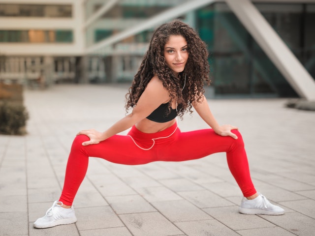 selective-focus-photo-of-smiling-woman-in-red-yoga-pants-and-3764394